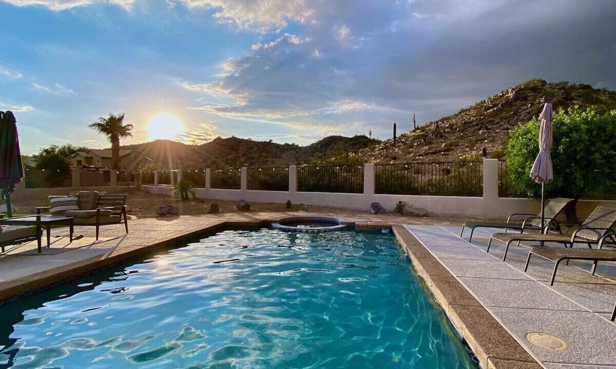 Mountain Park Ranch House | Relax and recharge at this stylish desert retreat with views of rolling desert hills. Enjoy sunsets from the heated pool, dine outdoors, or unwind with a few on the putting green. Perfect for long stays—just 15 minutes from the airport!