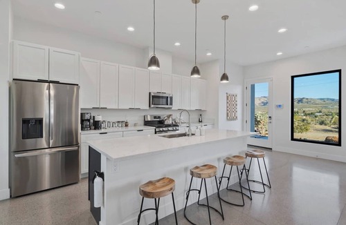 Yucca Valley House | A serene luxury desert retreat near Joshua Tree National Park with panoramic mountain views, a private pool and spa, an open-air rain shower sanctuary, and an expansive stargazing patio in the Mojave Desert.